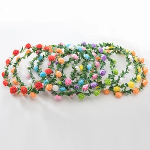 Detail of vibrant foam rose wreaths in red, blue, and yellow with green leaf accents