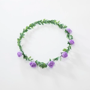 Detail view of artificial purple foam rose headband with green leaves for festivals