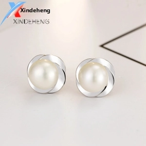 Macro detail of elegant S925 sterling silver pearl stud earrings with petal frame