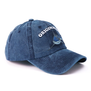 Detail of vintage washed blue cotton baseball cap with shark and original embroidery