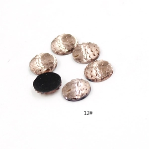 Macro shot of 12mm rose gold fish scale resin cabochons with shiny iridescent finish