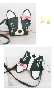 Detail of green puppy crossbody bag with pink bow and fine embroidery for girls