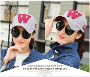 Detail of grey baseball cap with red letter W patch embroidery and side decorative stitching