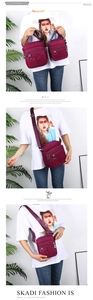 Detailed comparison of medium and small purple nylon crossbody bags with multiple zippers