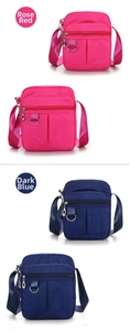 Detail of nylon crossbody bag with multi-pocket design in rose red and navy blue