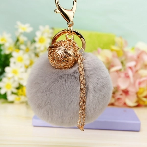 Porte-clés pompon gris mignon avec breloque fleur dorée et fermoir mousqueton