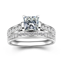 Macro detail of princess cut opal silver ring set with matching pave wedding band