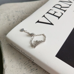 Detail showing adjustable silver crown chain ring with sparkling cubic zirconia accents