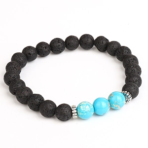 Black lava rock and turquoise stone beads bracelet with silver spacers on white background