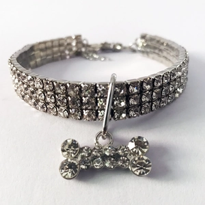 Detail of three-row rhinestone pet collar with a sparkling bone-shaped crystal pendant