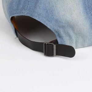 Adjustable washed denim baseball cap with leather strap and metal buckle closure