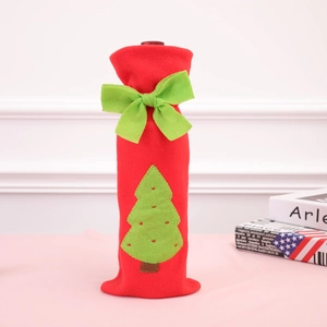 Christmas wine bottle cover featuring a red felt body with green bow and tree applique