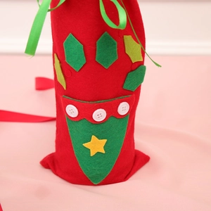 Detail of red felt Christmas wine gift bag with green applique and white buttons