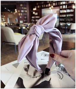 Detail view of light purple fabric bow headband with soft washed chiffon texture