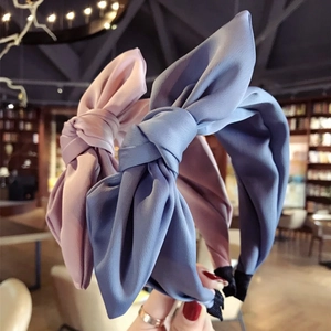 Elegant solid color fabric headband with large bow in pink and blue satin finish