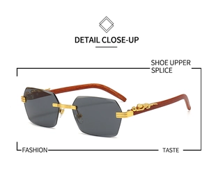 Detail view of grey rimless sunglasses featuring golden leopard decor and wood texture arms