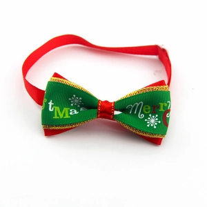 Macro detail of Christmas pet bow tie featuring red and green ribbon with snowflake prints