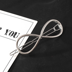 Detail view of silver infinity symbol hair clip with a minimalist metal finish design
