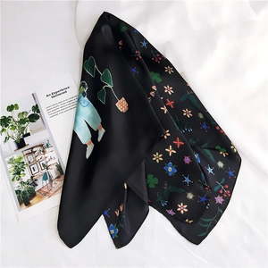 Detail of black silk scarf with artistic illustration and floral print on linen background