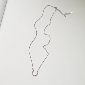 Detail of S925 sterling silver horseshoe pendant with adjustable lobster clasp chain
