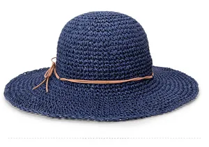 Detail view of navy blue woven straw hat with brown leather cord and bow decoration