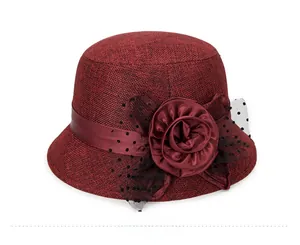 Detail of burgundy linen sun hat with elegant fabric flower and polka dot mesh decor
