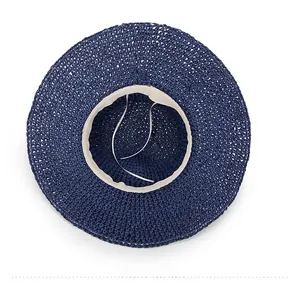 Detail of navy straw hat interior featuring a white sweatband and adjustable drawstring