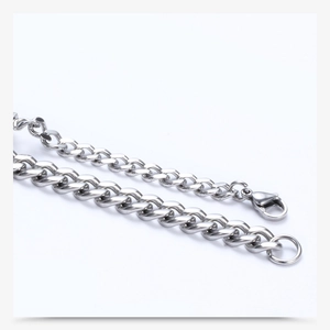 Detailed macro view of polished stainless steel silver curb chain with secure lobster clasp