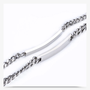 Close-up of polished stainless steel 7mm curb chain bracelets with curved metal plate detail
