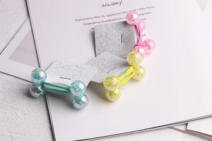 Three-color hair ties with glitter resin beads displayed on silver glitter cardstock