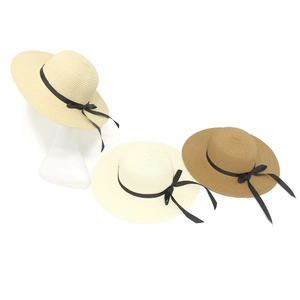 Detailed close-up showing straw sun hats in creamy white, natural, and khaki with black bows