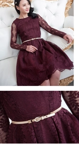 Detailed macro view of the intricate floral lace fabric and golden belt buckle of this dress