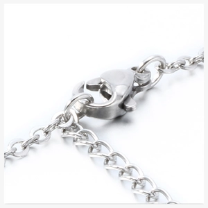 Detailed macro shot of silver stainless steel lobster clasp and delicate necklace chain