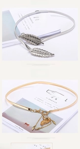 Detail of elegant gold fox and silver leaf metal elastic waist belts with leaf clasps