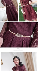Detail of burgundy floral lace fabric and gold elastic belt with rhinestone leaves