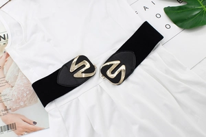 Detail of wide black elastic waist belt with decorative geometric gold alloy buckle