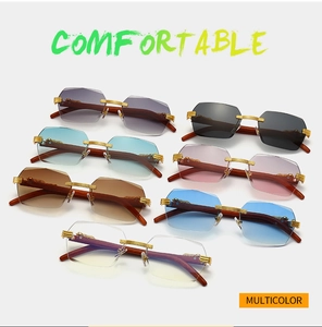 Detailed display of rimless sunglasses featuring geometric cut lenses and wood grain temples