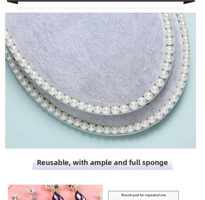Detail of oval jewelry board with grey velvet fabric and white pearl edge decorations