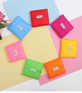 Detailed view of 7 colorful foldable nylon shopping bags with BAG labels arranged in a circle
