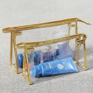 Set of two transparent PVC makeup bags with gold trim and waterproof zipper closure