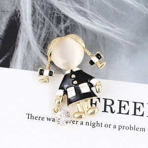 Close-up of a cartoon girl brooch with opal stone, rhinestone, and gold alloy finish