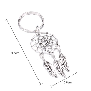 Detailed view of silver dreamcatcher keychain showing 9.5cm length and feather pendants