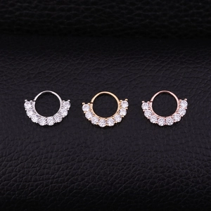 Three zircon micro-paved nose rings in silver, gold and rose gold on black leather