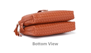 Detail view of the woven leather bottom featuring a dual gold zipper compartment design