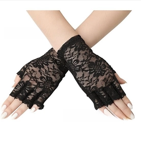 Close-up of black lace fingerless gloves with elegant floral patterns and scalloped edges