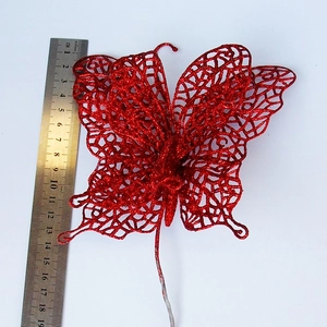 Detail of a 15cm red glitter butterfly ornament with mesh texture and metal stem