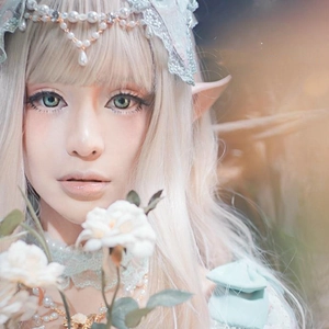 Detail of latex elf ears and light green lace headband with pearls for cosplay