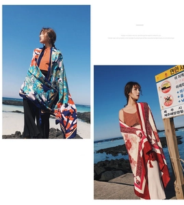 Detail of tropical palm leaf and floral prints on lightweight cotton linen shawls