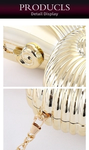 Detailed close-up of shell-shaped gold evening clutch showing metallic texture and chain
