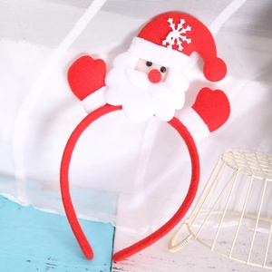 Detail of Christmas headband featuring Santa Claus hat and red gloves on rustic wood
